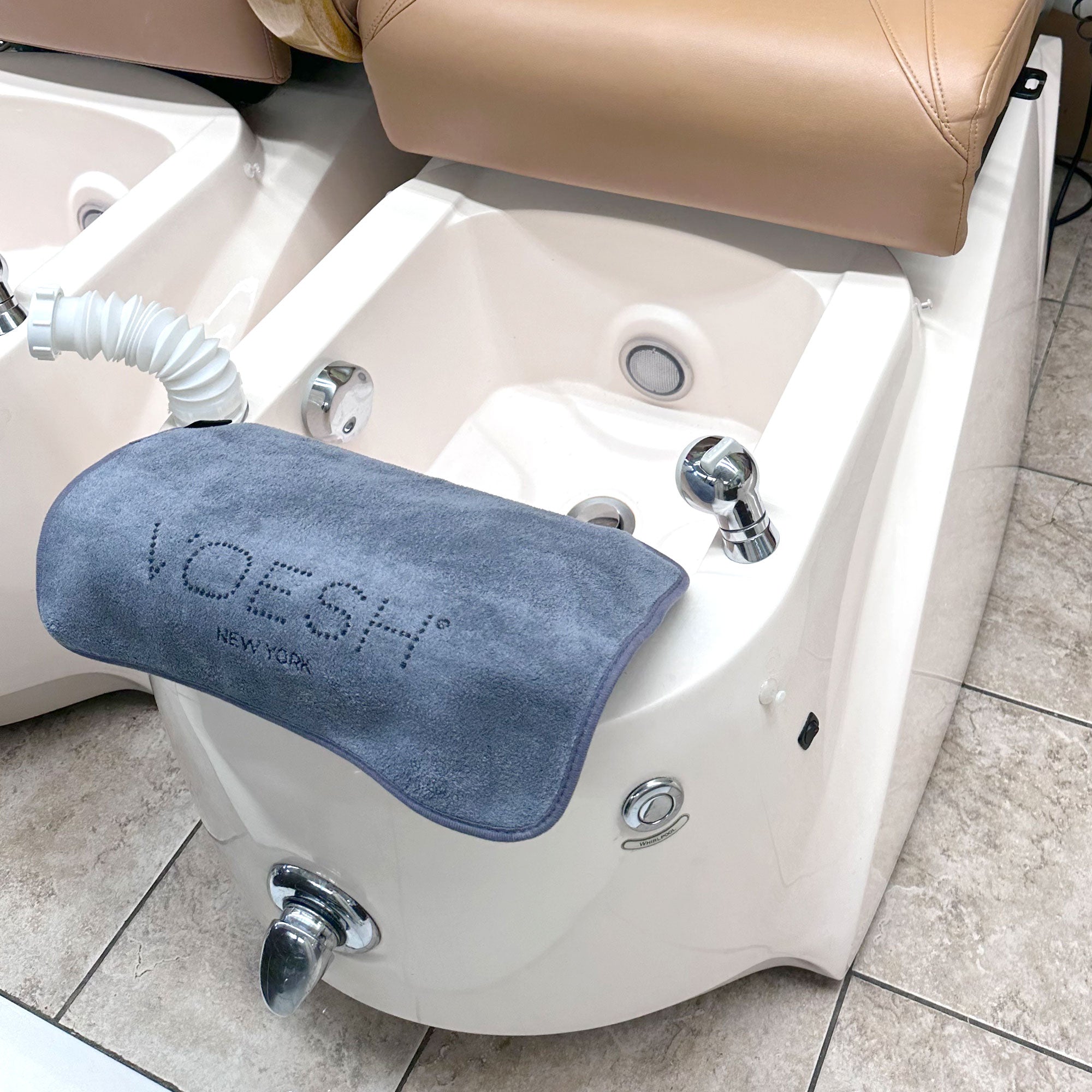 Voesh gray microfiber pedi towel on a pedicure tub
